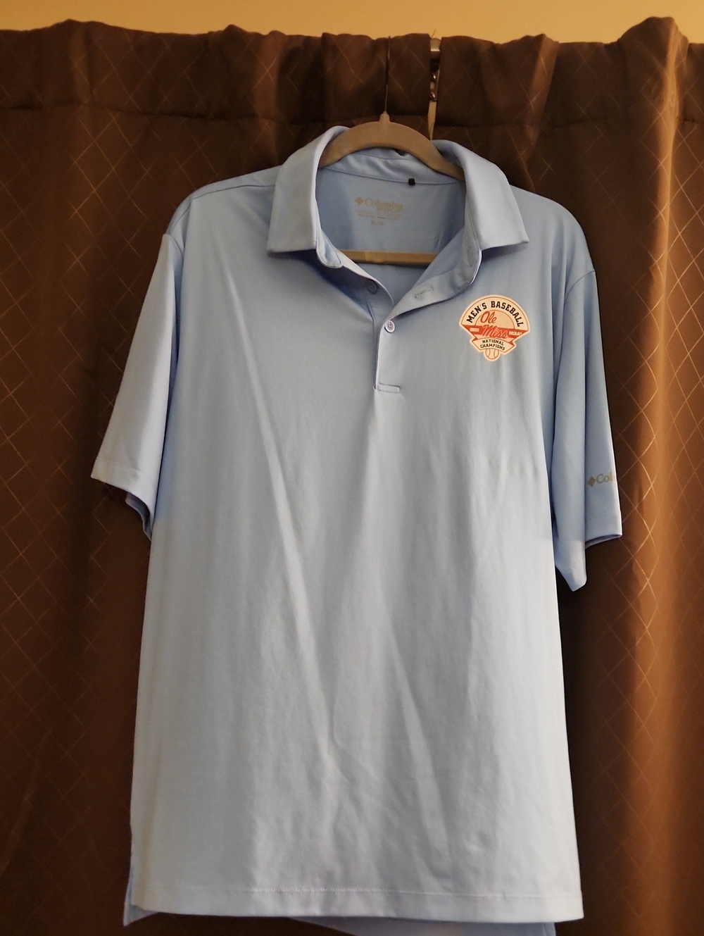 Columbia Men’s Light Blue Polo with Ole Miss 2022 NCAA Championship Logo